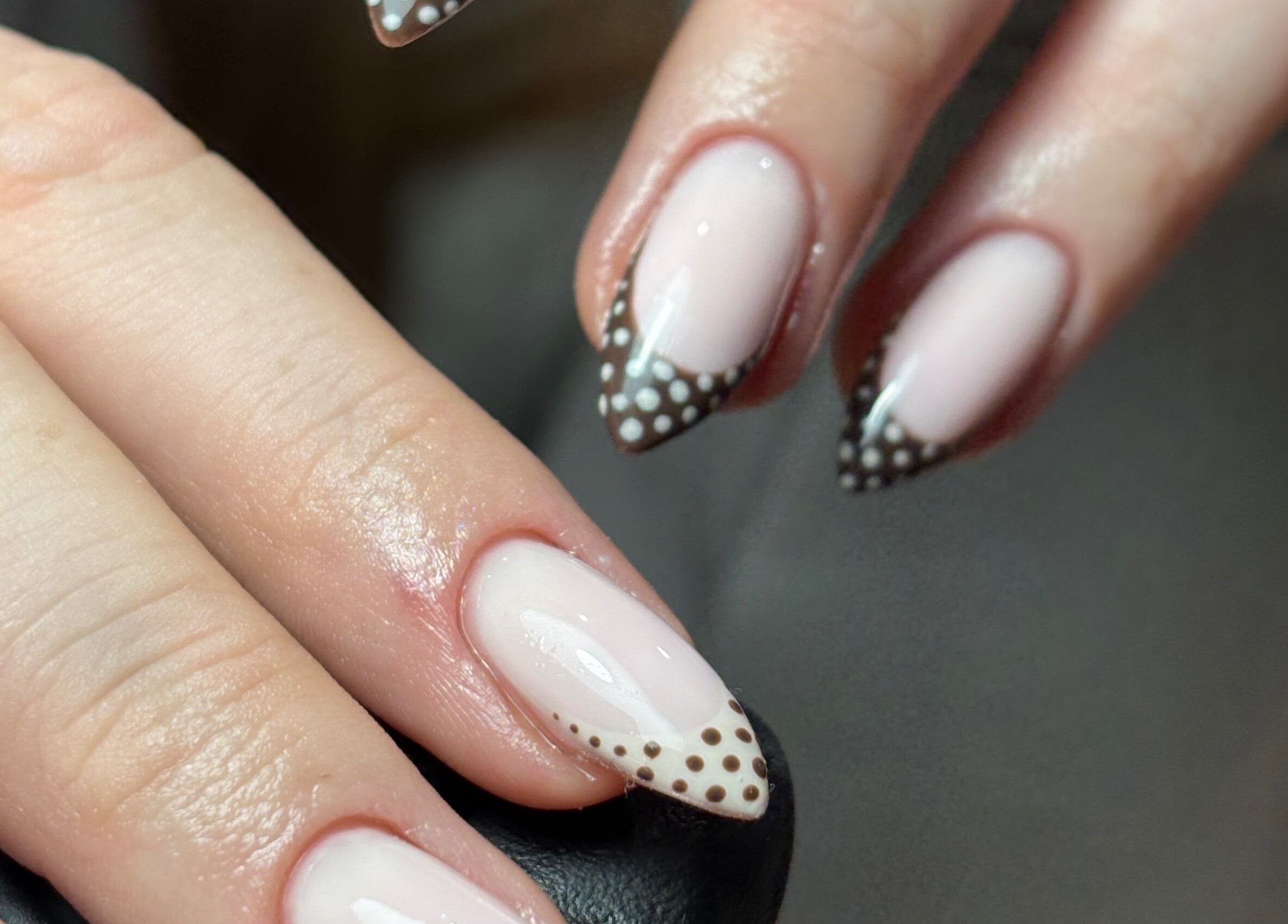 Elegant polka dot nail design at eviemariebeauty in Thurnscoe, England, GB. Stylish and chic manicure.