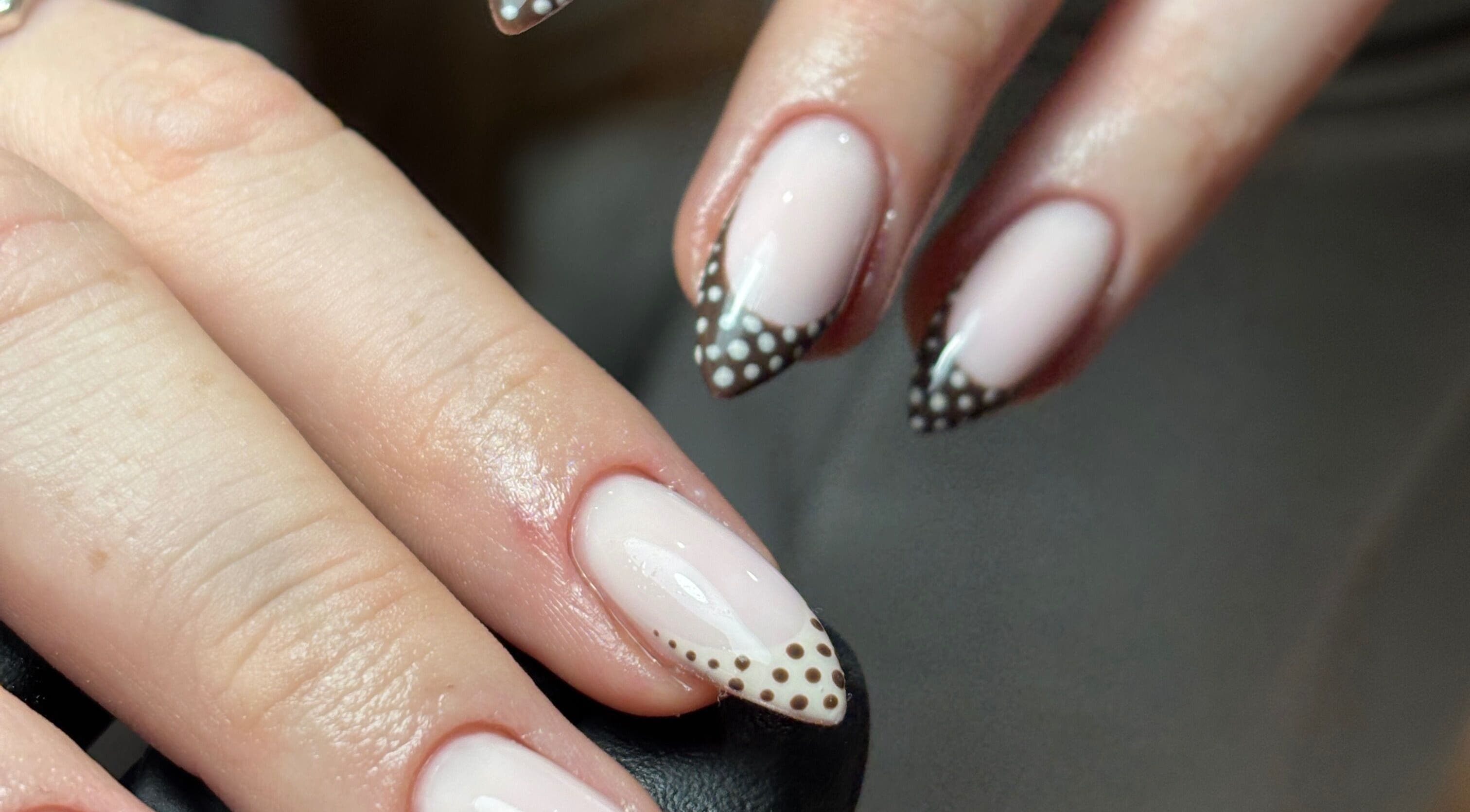 Elegant polka dot nail design at eviemariebeauty in Thurnscoe, England, GB. Stylish and chic manicure.
