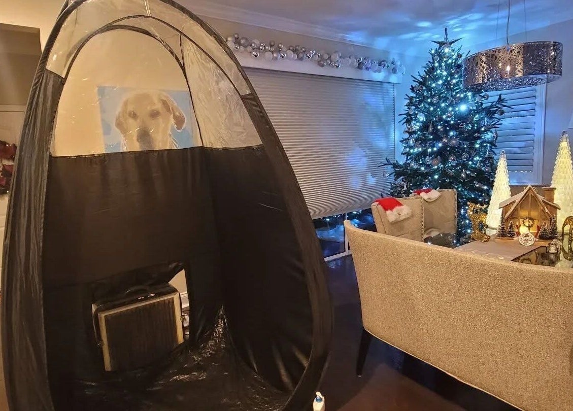 Cozy festive setup at Glow on the Go, Paisley, Scotland, GB, featuring a tanning tent and holiday décor.
