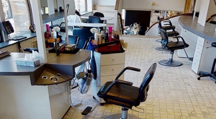 Modern salon interior at JulietteHaistylist, Montréal, Québec, CA with sleek styling chairs and workstations.