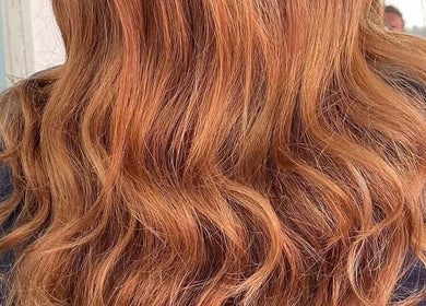 Vibrant copper waves styled at D Code Hair & Nails, Ħaż-żebbuġ, MT, showcasing expert hair styling.