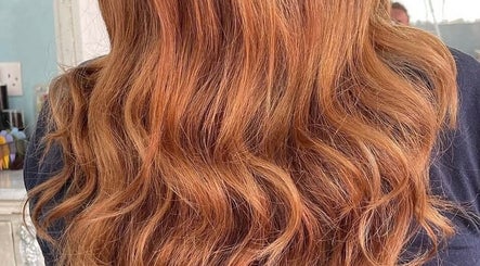 Vibrant copper waves styled at D Code Hair & Nails, Ħaż-żebbuġ, MT, showcasing expert hair styling.