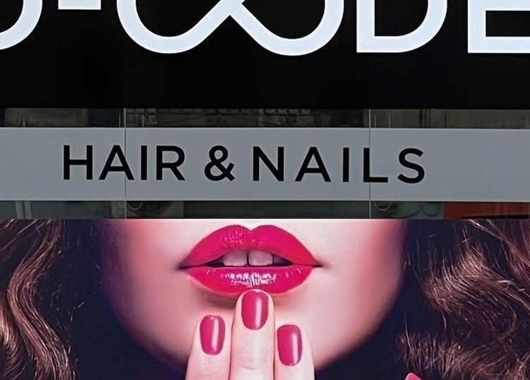 D Code Hair & Nails sign in Ħaż-żebbuġ, MT showcases bold style with vibrant lips and nails.