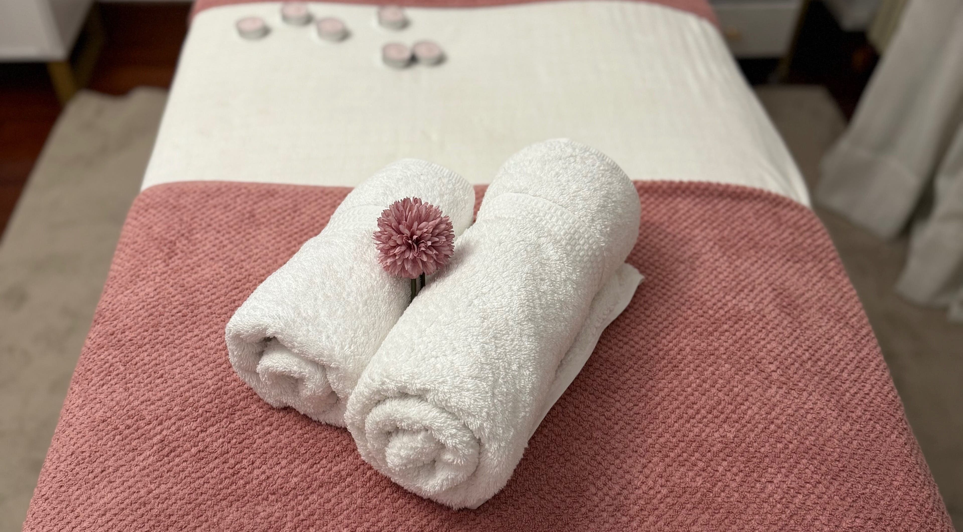 Toallas enrolladas y flor en Adri Oliver Masajes Bienestar, Donostia / San Sebastián, Euskadi, ES.