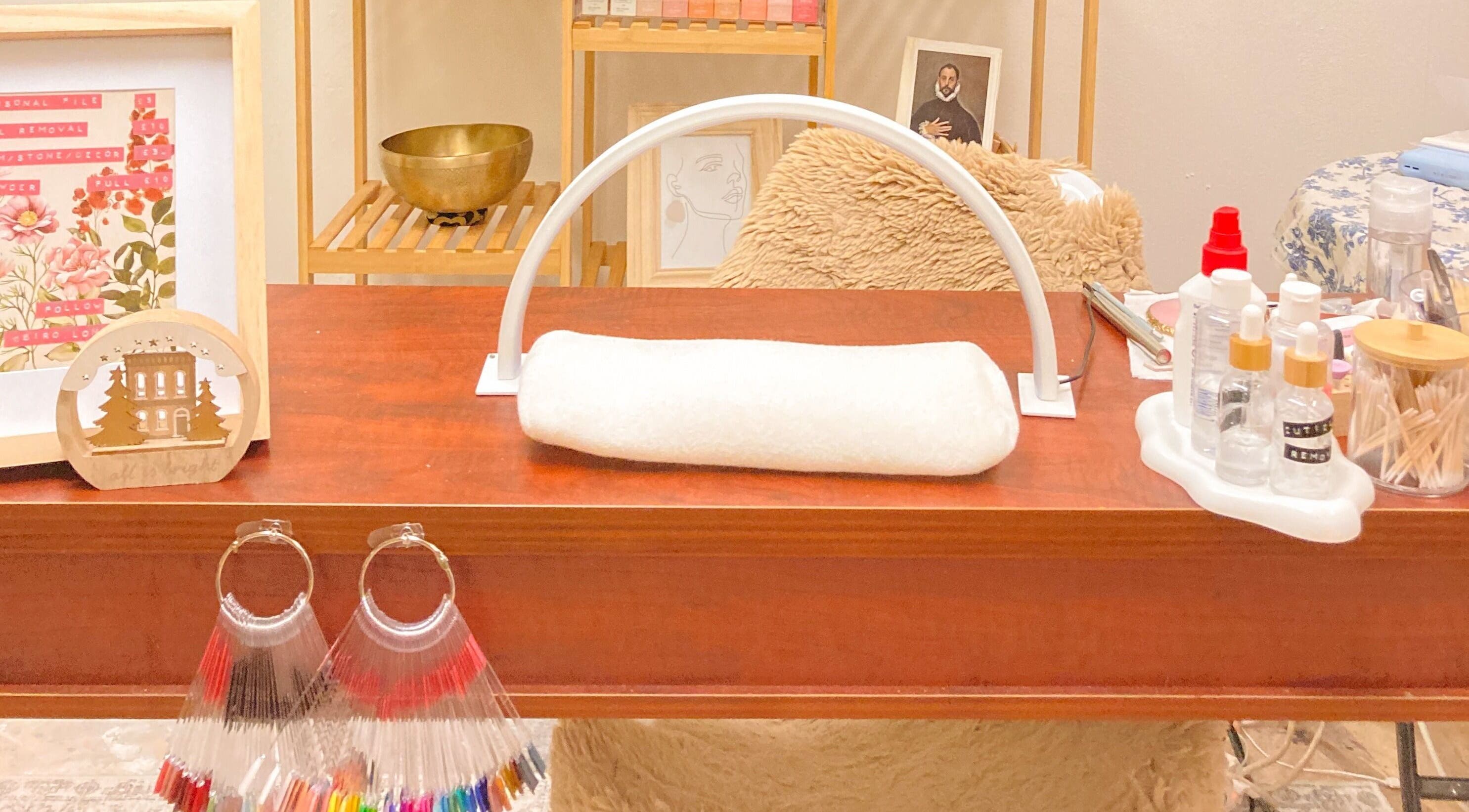 Manicure station at Biro Korean Nail Salon, London, England, GB featuring nail colors and relaxing decor.