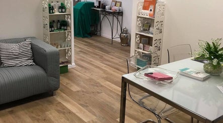 Relaxing lounge area at Beingwell, Dundee, Scotland, GB with sofa, stylish decor, and wellness products.