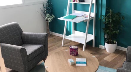 Chic waiting area at Beingwell, Dundee, Scotland, GB with armchairs, table, and vibrant decor.