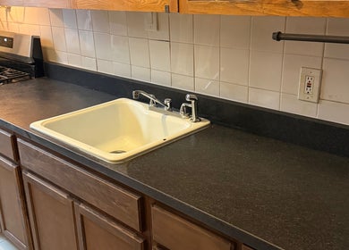 Modern kitchen sink and counter at CLEWIS IN CONSTRUCTION LLC, Queen, US.