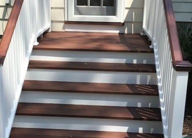 Stylish wooden stairs at CLEWIS IN CONSTRUCTION LLC, Queen, US, showcasing craftsmanship and design.