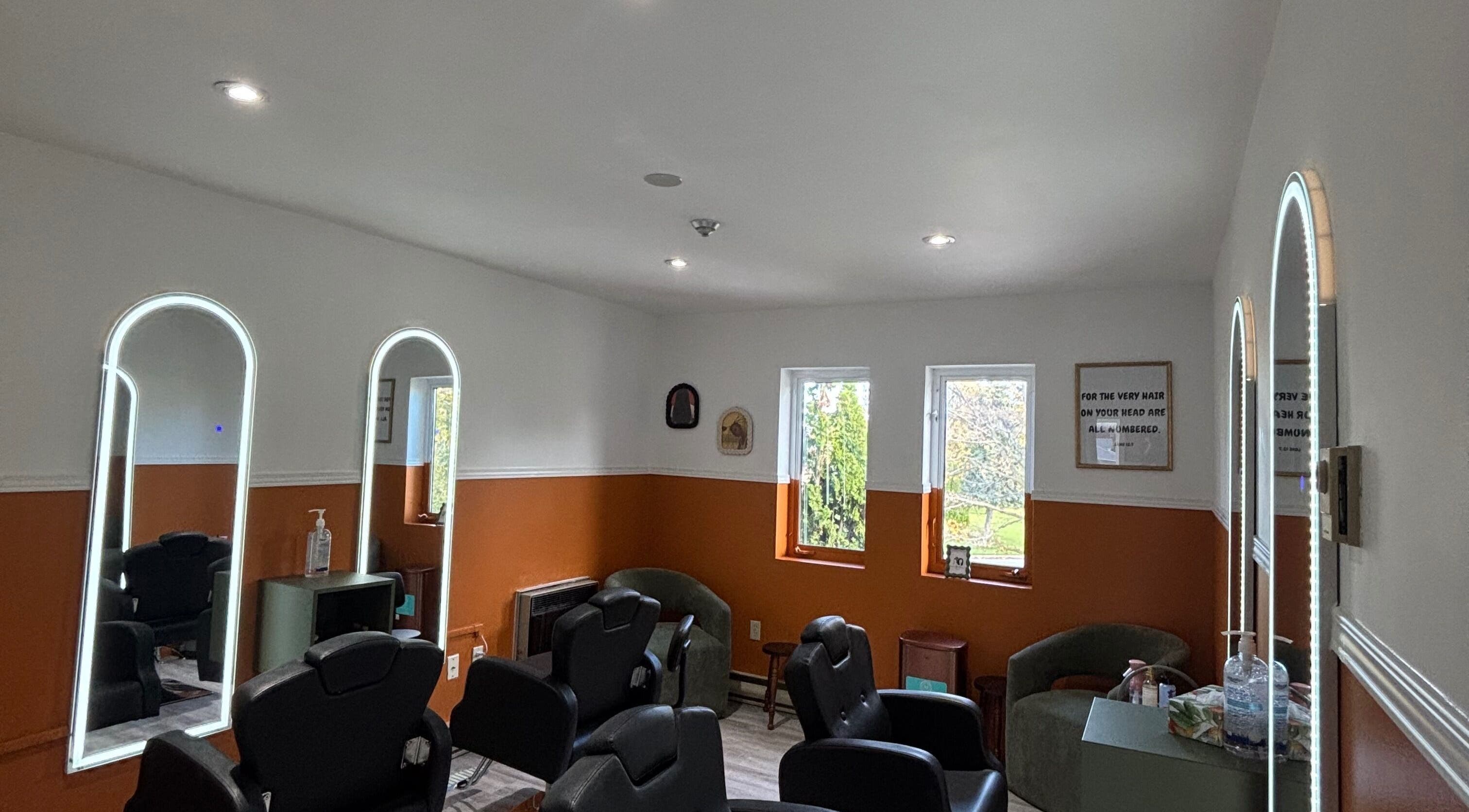 Modern salon seating at Beauty Braids Locs Niagara in St. Catharines, Ontario, CA with stylish mirrors.