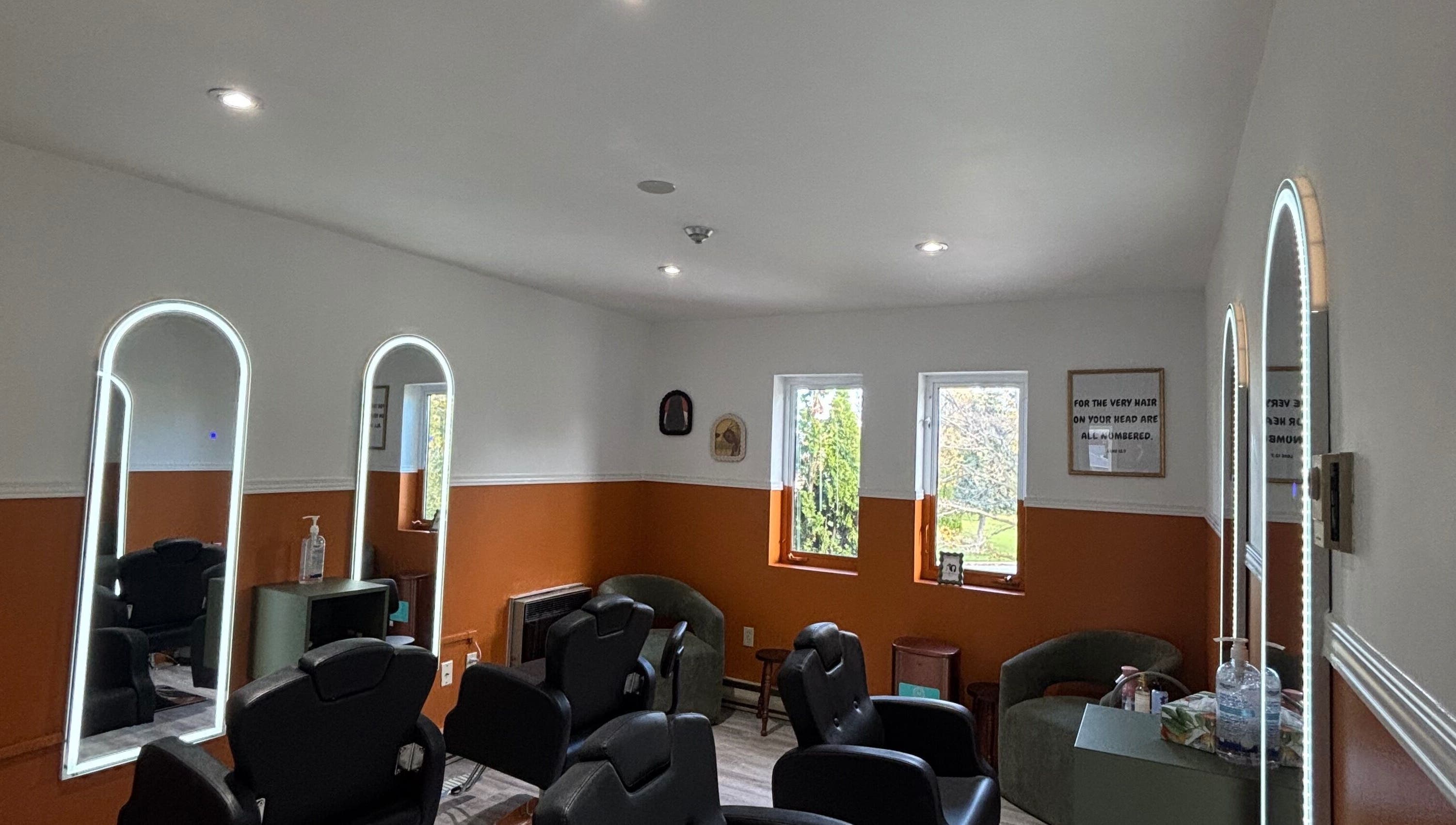 Modern salon setup at Beauty Braids Locs Niagara in St. Catharines, Ontario, CA with stylish mirrors and seating.
