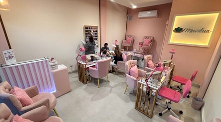 MAVILUA NAILS salon interior with pink decor in Monterrey, Nuevo León, MX, showcasing plush seating and manicure service.