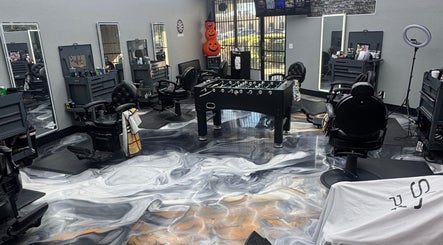 The Spot barbershop in Los Angeles, California, US features chic chairs and a foosball table for a modern vibe.