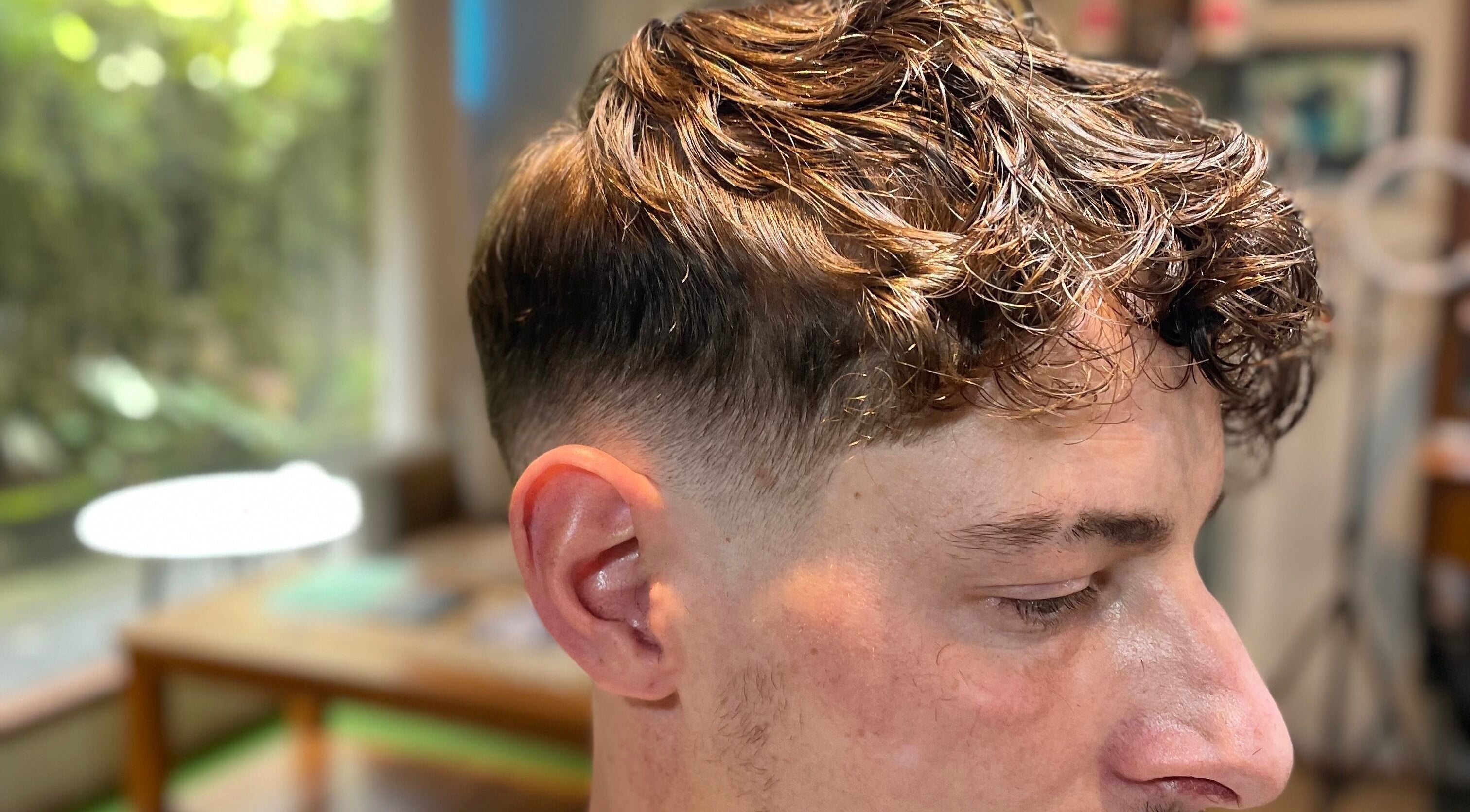 Close-up of a stylish haircut at Warsa Barbershop, showcasing a fresh tapered style in Bali, Bali, ID.