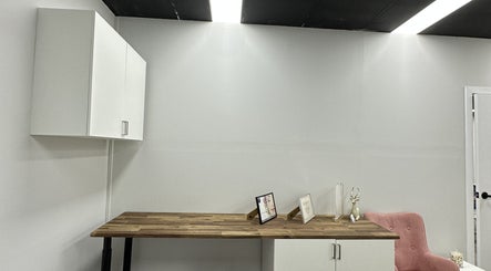 Modern workspace at Lash.PrettyUp with wooden desk and pink chair, Melbourne, Victoria, AU.