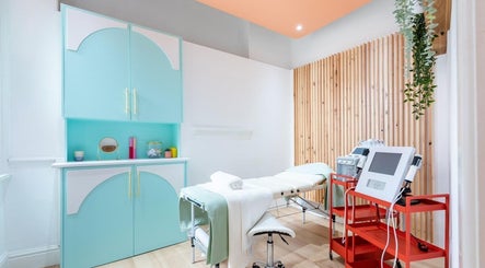 Bright, modern treatment room at Dr Jaymi Aesthetics, Manchester, England, GB. Features a massage table and equipment.