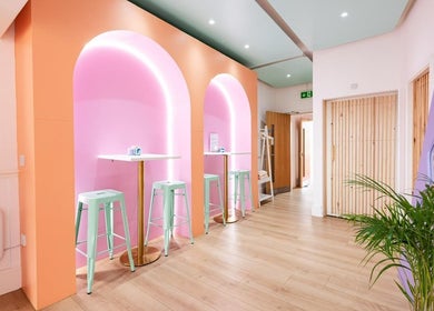 Stylish seating area at Dr Jaymi Aesthetics, Manchester, England, GB with pastel tones and modern decor.