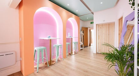 Stylish seating area at Dr Jaymi Aesthetics, Manchester, England, GB with pastel tones and modern decor.