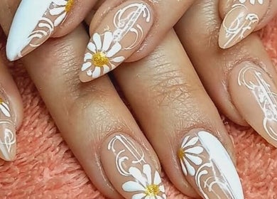 Elegant floral nail art at BellaZoe Nail Salon in Klerksdorp, North West, ZA on a stylish pink background.