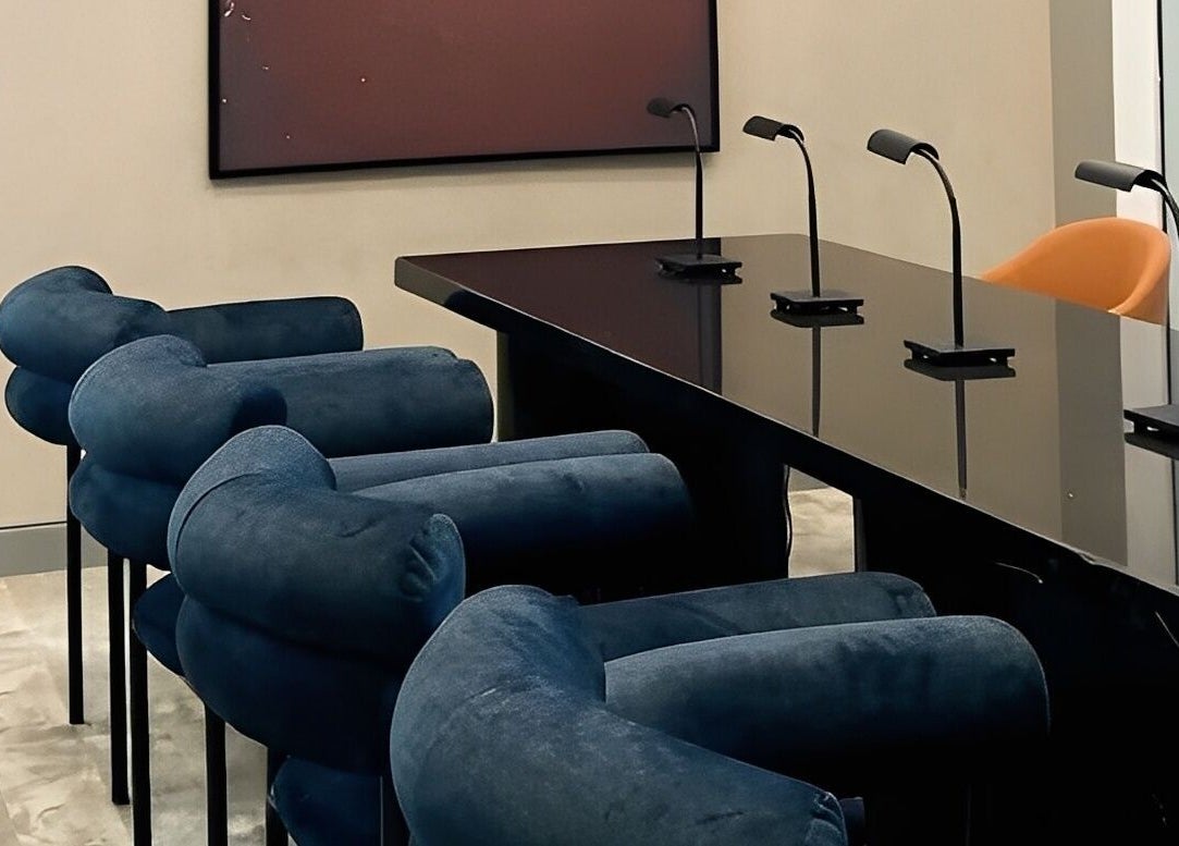 Modern seating at Aiona - The Art of Nails, Lagos, Lagos, NG, featuring sleek black tables and blue chairs.