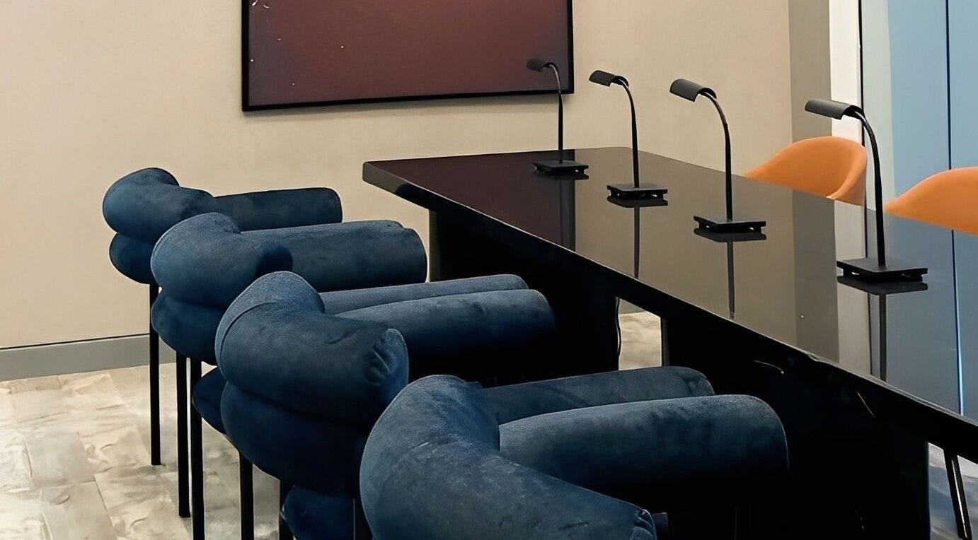 Modern seating at Aiona - The Art of Nails, Lagos, Lagos, NG, featuring sleek black tables and blue chairs.