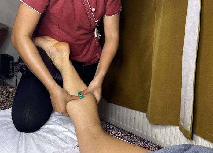 Masseuse performing leg massage at Original Thai Massage in Brighton by Pear, Brighton, Brighton, GB.