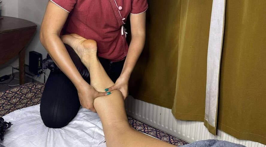 Masseuse performing leg massage at Original Thai Massage in Brighton by Pear, Brighton, Brighton, GB.