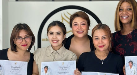 Smiling group at Magicallybyzz, Petaling Jaya, receiving certificates in beauty and wellness.