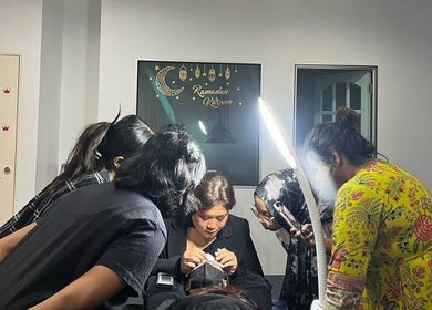 Team at Magicallybyzz Petaling Jaya, Selangor, MY, engaged in detailed beauty work under bright lighting.
