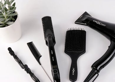 Salon tools at Sleeks Salon in Toronto, Ontario, CA feature a hair dryer, brushes, and plant.