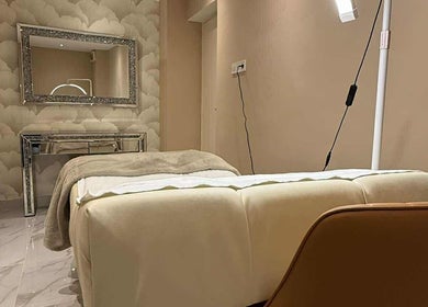 Elegant treatment room at D'luxe Beauty Salon, Budapest, Magyar, HU, with plush bed and chic decor.