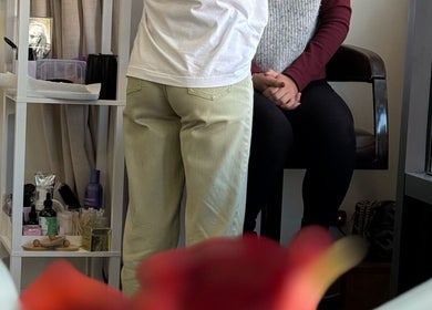 Client enjoying a relaxing beauty treatment at dawa.brows, New York, New York, US, with products in the background.