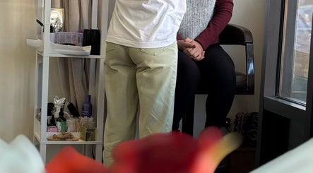 Client enjoying a relaxing beauty treatment at dawa.brows, New York, New York, US, with products in the background.