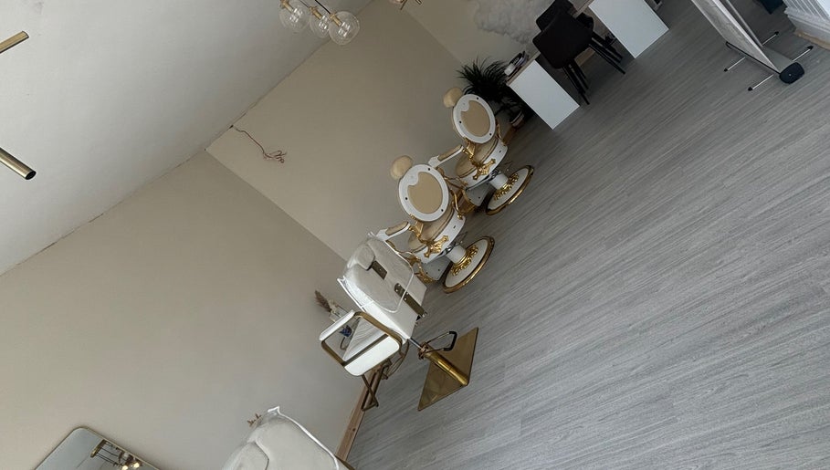 Elegant beauty salon with gold-accented chairs at Bychloeleigh, Wales, Wales, GB.