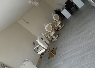 Elegant beauty salon with gold-accented chairs at Bychloeleigh, Wales, Wales, GB.