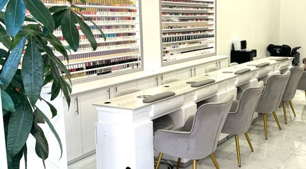Elegant nail salon interior at Moon Beauty, London, England, GB showcasing plush seating and polish display.