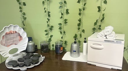 Massage essentials at Sleepy Koi Bodyworks, Swartz Creek, Michigan, US, featuring hot stones and towels.