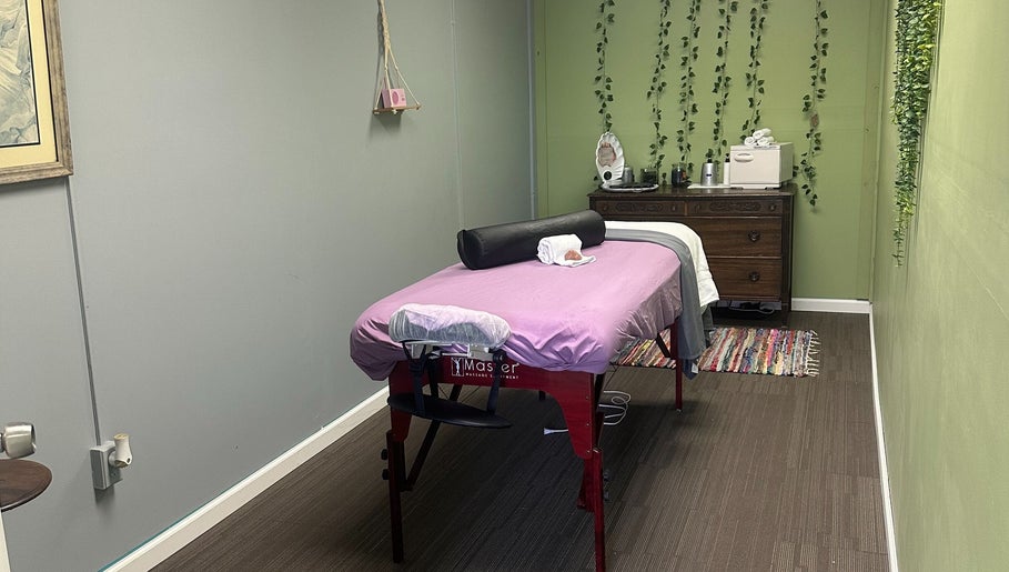 Cozy massage room at Sleepy Koi Bodyworks, Swartz Creek, Michigan, US, featuring a massage table with calming decor.