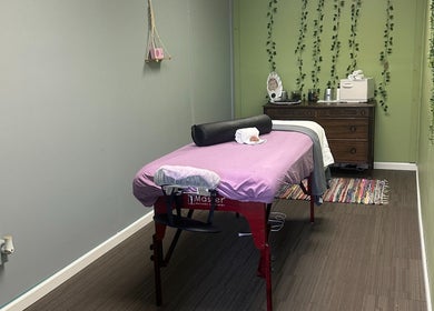 Cozy massage room at Sleepy Koi Bodyworks, Swartz Creek, Michigan, US, featuring a massage table with calming decor.