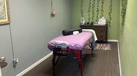 Cozy massage room at Sleepy Koi Bodyworks, Swartz Creek, Michigan, US, featuring a massage table with calming decor.