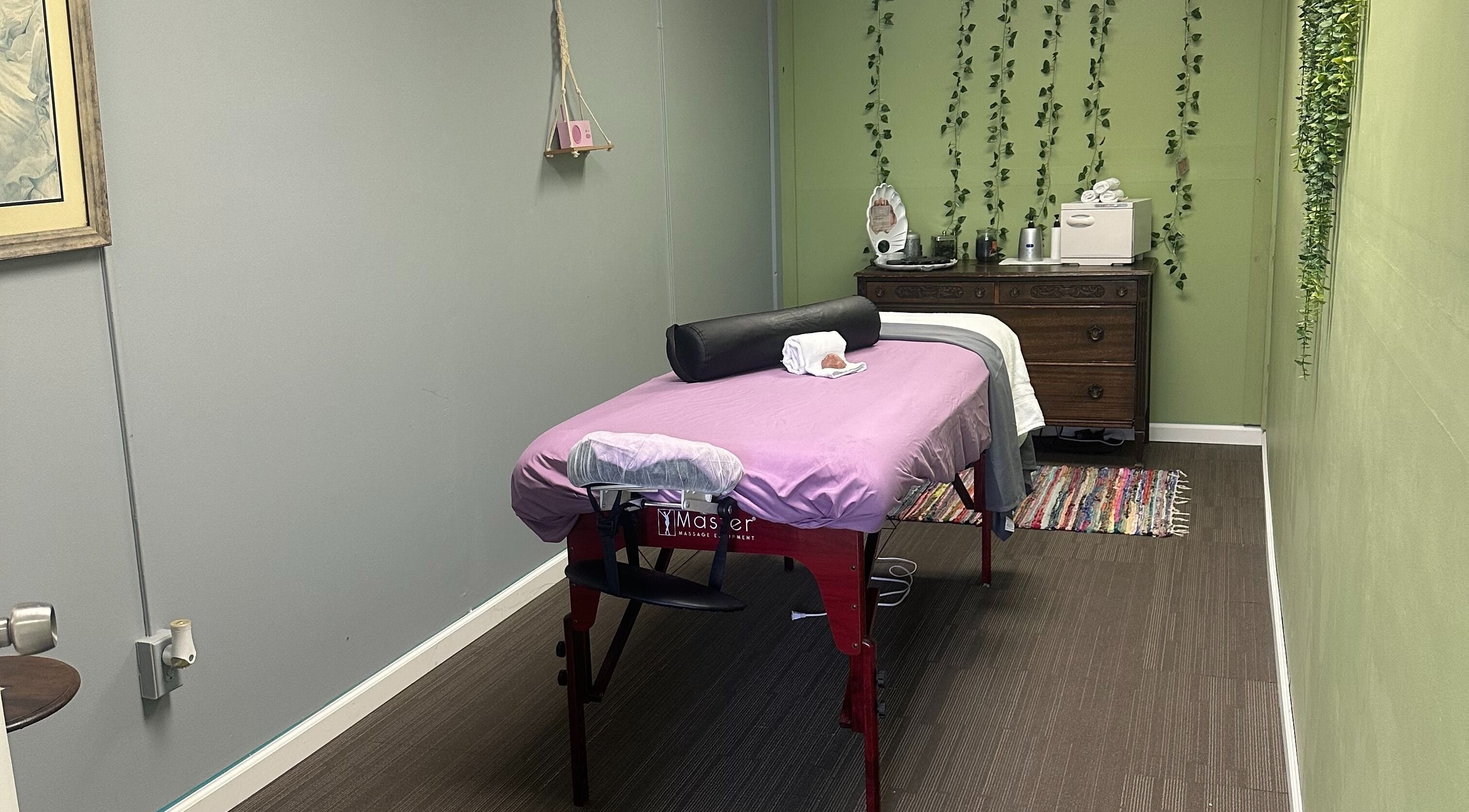 Cozy massage room at Sleepy Koi Bodyworks, Swartz Creek, Michigan, US, featuring a massage table with calming decor.