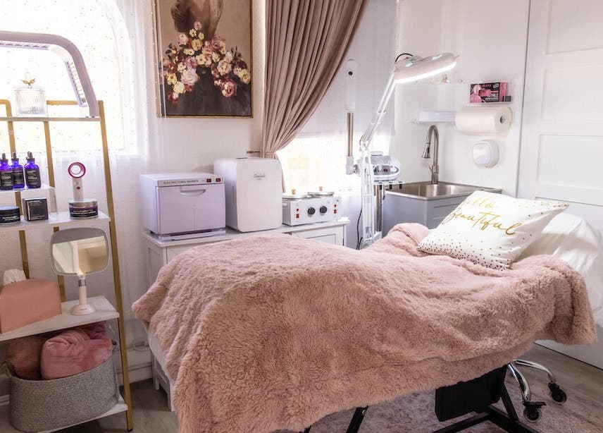 Spa treatment room at Vanity Artistry, Winter Park, Florida, US with plush decor and skincare products.