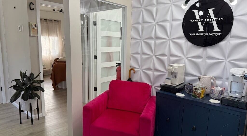 Cozy corner at Vanity Artistry, Winter Park, Florida, US featuring a pink chair and modern decor.