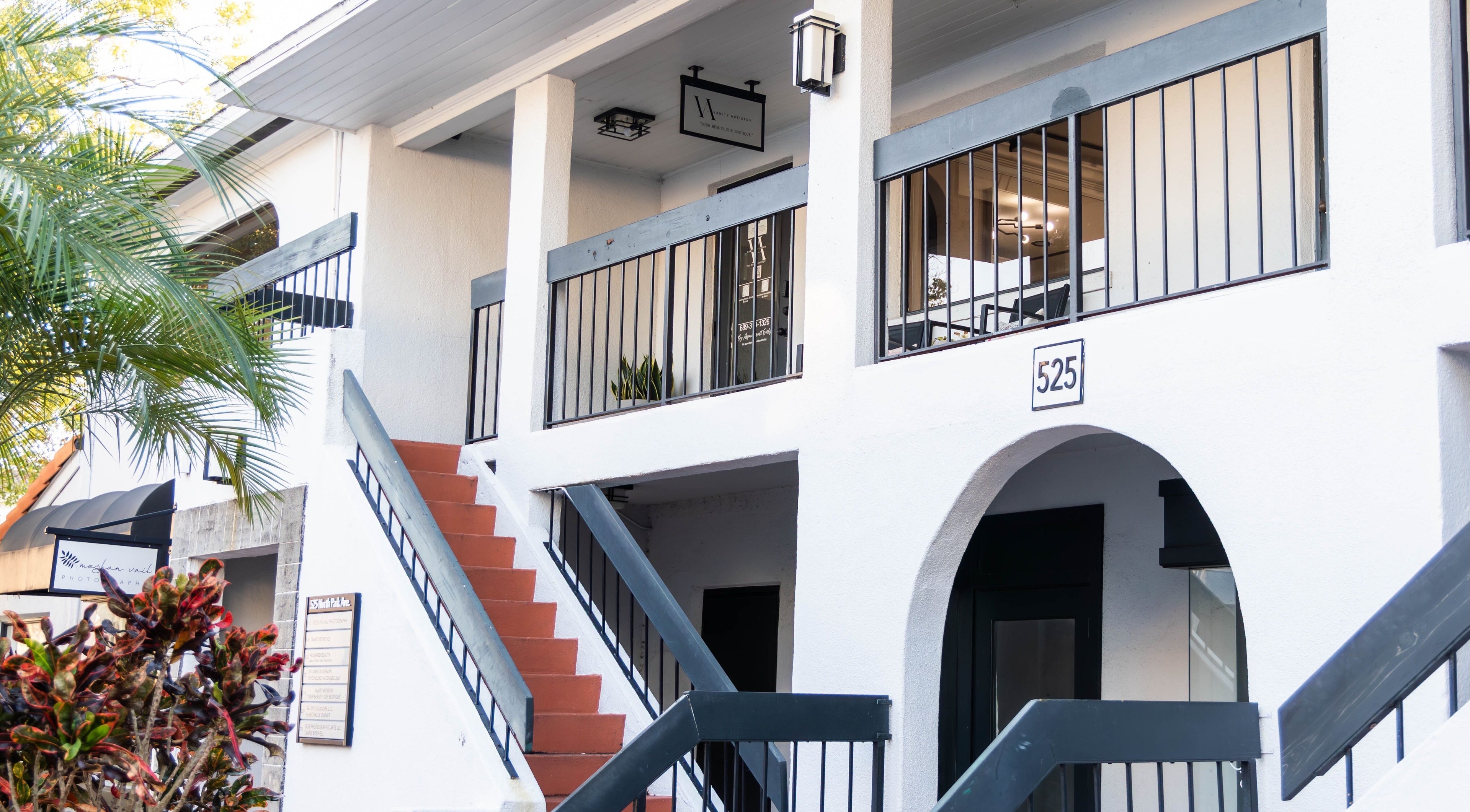 Front view of Vanity Artistry located in Winter Park, Florida, US. Elegant white building with stairs.