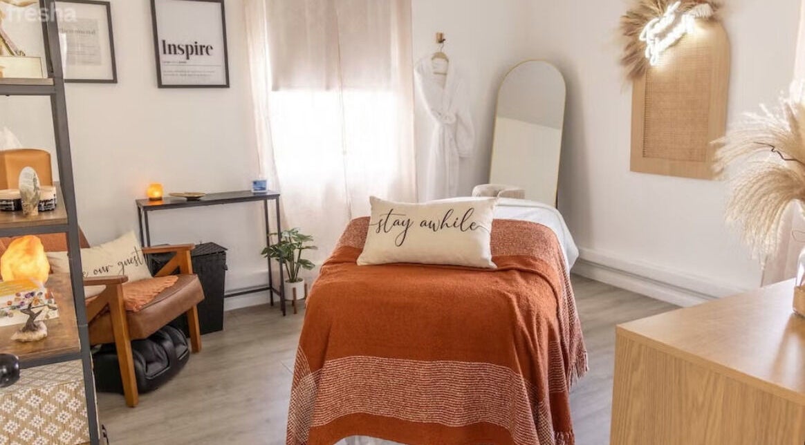 Cozy spa room at Aisxia, Vanity Artistry, Winter Park, Florida, US with warm decor and relaxation bed.