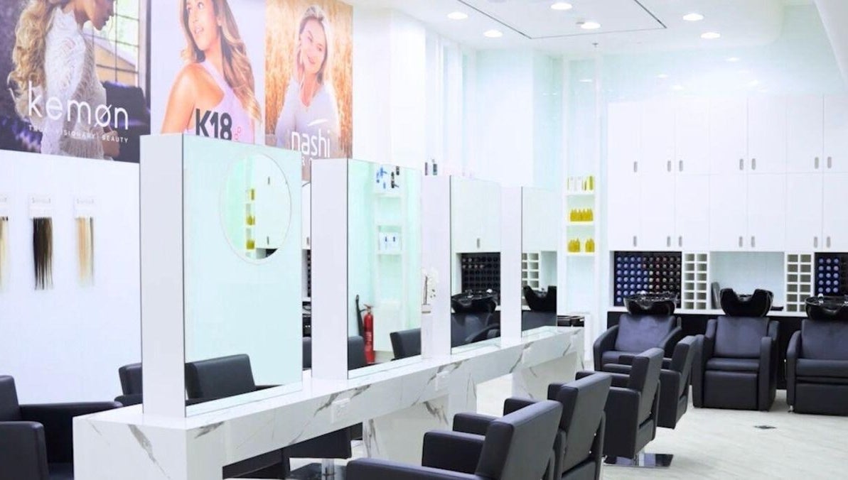Contemporary salon interior at Hair Colosseum Beauty Salon, Dubai, AE, featuring sleek styling chairs and mirrors.