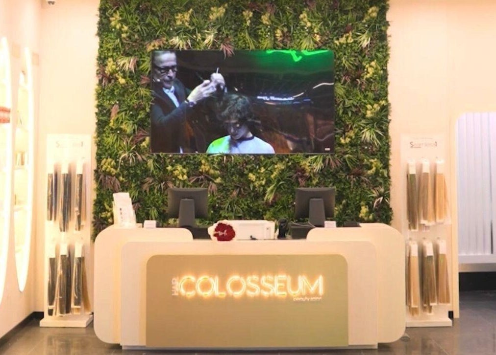Reception at Hair Colosseum Beauty Salon, lush green wall, Dubai, AE.