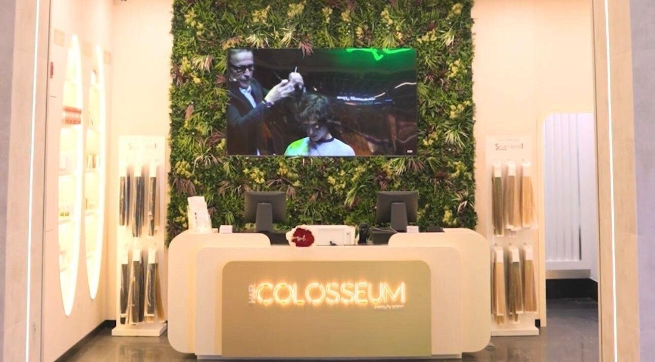 Reception at Hair Colosseum Beauty Salon, lush green wall, Dubai, AE.