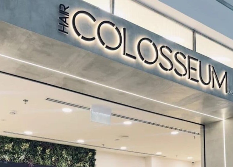 Entrance of Hair Colosseum Beauty Salon in Dubai, AE, showcasing modern design and inviting atmosphere.