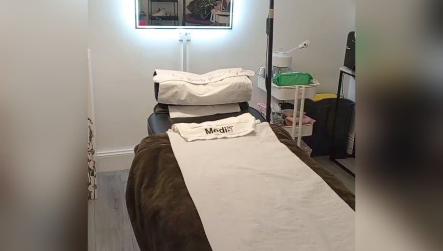 Relaxing treatment room at Little Beauty Secrets, Cowdenbeath, Scotland, GB featuring a cozy spa bed.